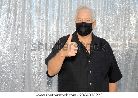 Photo Booth. A man Smiles and Poses for his pictures to be taken while in a Photo Booth at a Wedding or Party. People world wide love a good photo booth and get pictures printed while they wait. Smile
