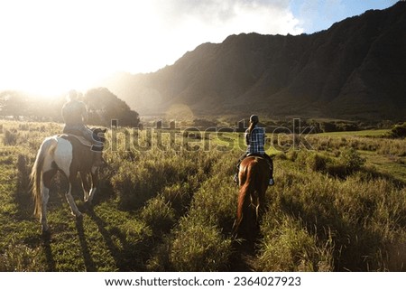 The sunset is riding a horse at Kualo Aranch Park in Hawaii Royalty-Free Stock Photo #2364027923