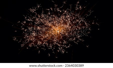 scattered golden firework bursting in the night sky