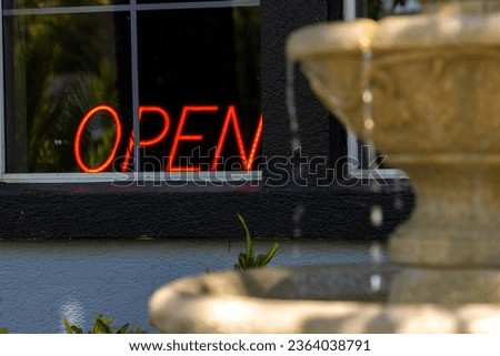 Neon open sign in business window downtown