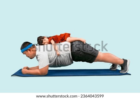 Cute moment Overweight father doing plank exercise while daughter on his back. Isolated over blue background Royalty-Free Stock Photo #2364043599