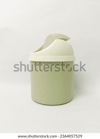 Green mini dustbin on white background