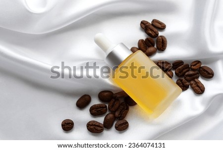 Skincare caffeine eye serum. Product bottle and coffee beans.   Caffeine skincare.  Royalty-Free Stock Photo #2364074131