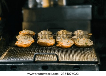 Grilled crab with cheese at Dongmun Market in Jeju Island, South Korea. This market is one of Jeju famous tourist spot. Royalty-Free Stock Photo #2364076023