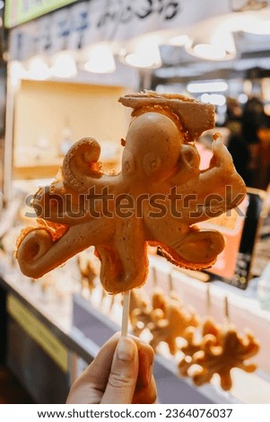 Squid shaped bread filled with cheese at the Dongmun Night Market. Royalty-Free Stock Photo #2364076037