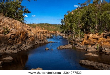 Forest river in red sandy rocks. River in forest. River water view. River in forest landscape