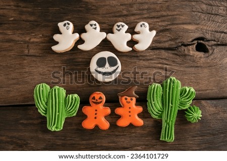 Homemade sweets cookies for halloween party. Traditional halloween gingerbread on wooden background