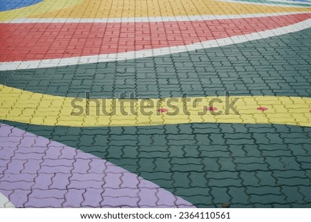 A close up picture of colourful crosswalk road during daytime.
