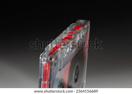 vintage analog audio cassette with transparent case and visible tape from the 80s
