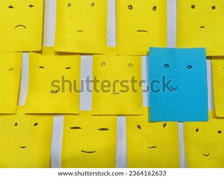 Various note cards with smiling and sad cartoon facial expressions in happiness versus depression there is one in particular that stands out with an optimistic smile