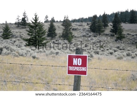 Sign NO TRESPASSING in mountains. NO TRESPASSING Sign in forest. 