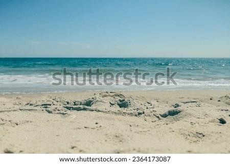 Summer beach on Coney Island. Pleasant, warm, salty water for your feet and body. A large expanse of beach that can accommodate a huge number of people. Those who wish can also ride a sail or jet ski.