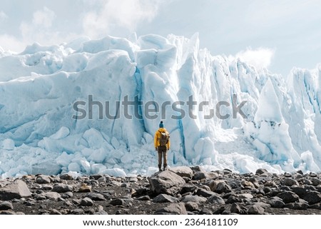 A man posing on the ice formation of the Perito Moreno glacier, Argentina Royalty-Free Stock Photo #2364181109