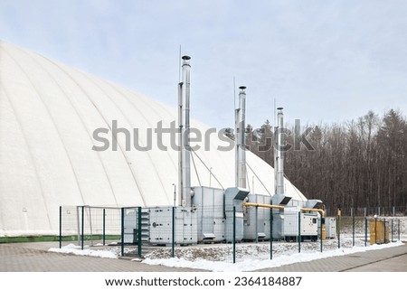 Inflatable air dome stadium. Inflated Football soccer air dome. Modern architecture example pneumatic stadium dome with heat generators, hot air blower and air conditioning system near winter forest. Royalty-Free Stock Photo #2364184887