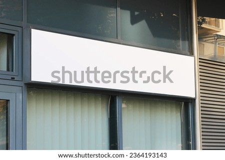 Blank white restaurant or shop signboard copy space mockup, large billboard banner on a storefront mock up template.