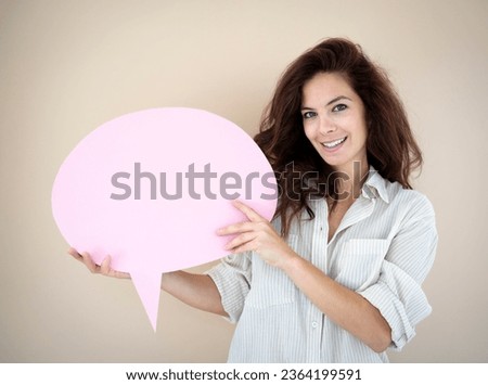 beautiful young woman with pink speech bubble in front of brown background