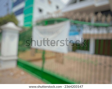 Defocused abstract background of luxury house with green fence for rent.