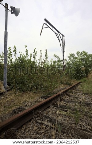 Abandoned  railroad switch and hut with loudspeaker on a cloudy day in the italian countryside