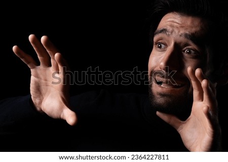 Frightened young beard man afraid scared and terrified with fear expression face He shield hands for stop something Guy were shock panic in the horror dark room Emotional and facial expression concept Royalty-Free Stock Photo #2364227811