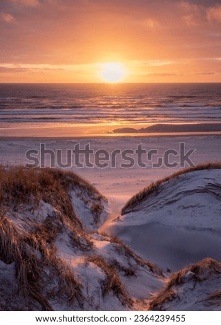 vivd and colorful sunset at the beach in denmark westcoast Royalty-Free Stock Photo #2364239455