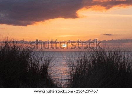 vivd and colorful sunset at the beach in denmark westcoast Royalty-Free Stock Photo #2364239457