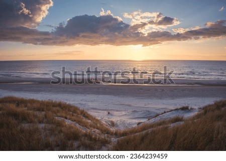 vivd and colorful sunset at the beach in denmark westcoast Royalty-Free Stock Photo #2364239459