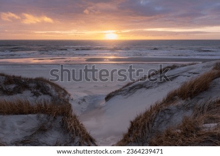 vivd and colorful sunset at the beach in denmark westcoast Royalty-Free Stock Photo #2364239471