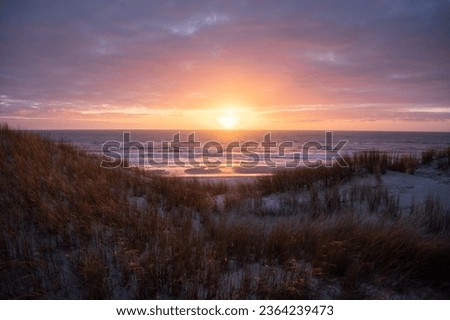 vivd and colorful sunset at the beach in denmark westcoast Royalty-Free Stock Photo #2364239473