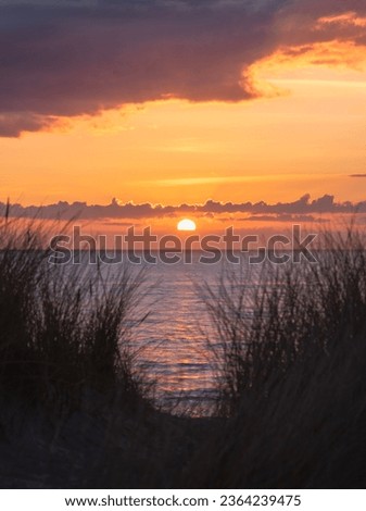 vivd and colorful sunset at the beach in denmark westcoast Royalty-Free Stock Photo #2364239475