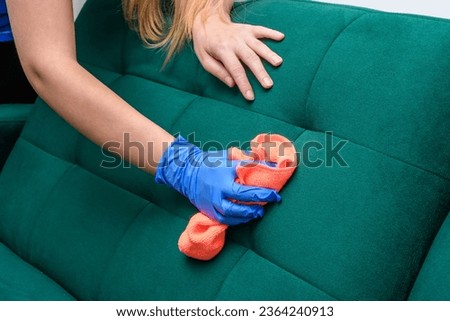 Clean the upholstery of the sofa in the living room Royalty-Free Stock Photo #2364240913