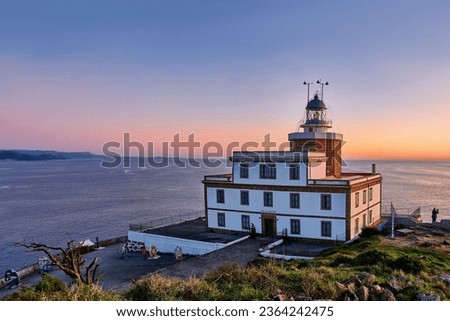 Sunset in the Lighthouse of the Finisterre cape, Costa de la Muerte, Galicia. Northern Spain. One of the last stages in the jacobian way. Royalty-Free Stock Photo #2364242475