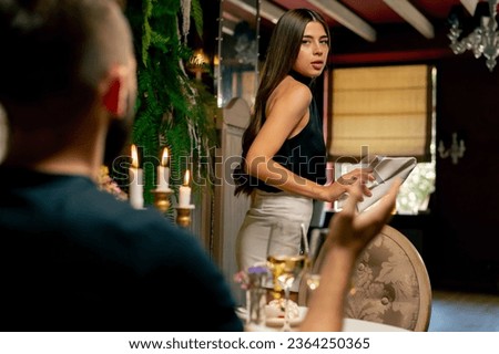 Close-up of a girl leaving a date with her boyfriend because of an argument during a date at Italian restaurant Royalty-Free Stock Photo #2364250365