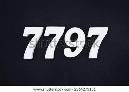 Black for the background. The number 7797 is made of white painted wood.