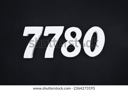 Black for the background. The number 7780 is made of white painted wood.
