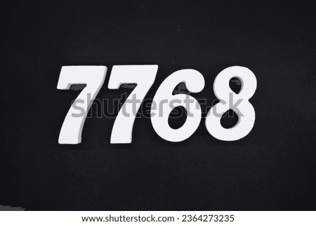 Black for the background. The number 7768 is made of white painted wood.