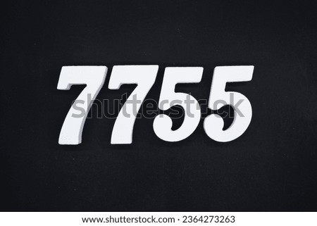 Black for the background. The number 7755 is made of white painted wood.