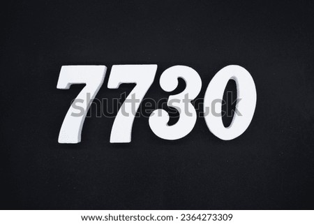 Black for the background. The number 7730 is made of white painted wood.