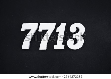 Black for the background. The number 7713 is made of white painted wood.