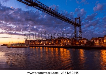 Long exposure of the Vizcaya Bridge in Portugalete, Spain at dusk. The Vizcaya Bridge is a transporter bridge that opened in 1893 and links the towns of Portugalete and Getxo in Biscay, Spain.