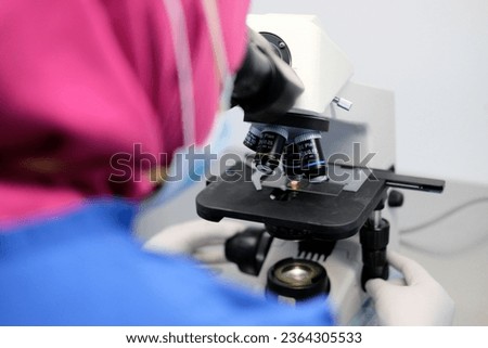 Scientist with Microscope Technology at Hospital Laboratory Royalty-Free Stock Photo #2364305533