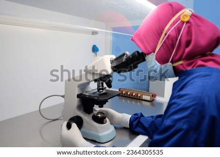 Scientist with Microscope Technology at Hospital Laboratory Royalty-Free Stock Photo #2364305535