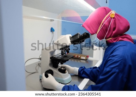 Scientist with Microscope Technology at Hospital Laboratory Royalty-Free Stock Photo #2364305541