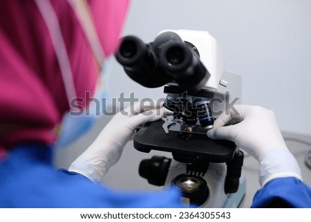 Scientist with Microscope Technology at Hospital Laboratory Royalty-Free Stock Photo #2364305543