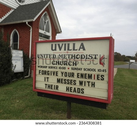 A large Methodist church sign advises FORGIVE YOUR ENEMIES 
  IT MESSES WITH THEIR HEADS. 