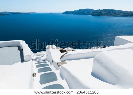 White architecture in Santorini island, Greece. Luxury hotel with sea view. Stairs to the sea. Travel and vacation concept