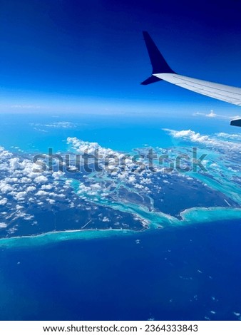 Airplane window view with blue sky