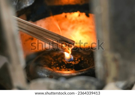 Wishing and pray for blessings in temple Thailand.joss sticks with candle to wish for good things in life. Royalty-Free Stock Photo #2364339413