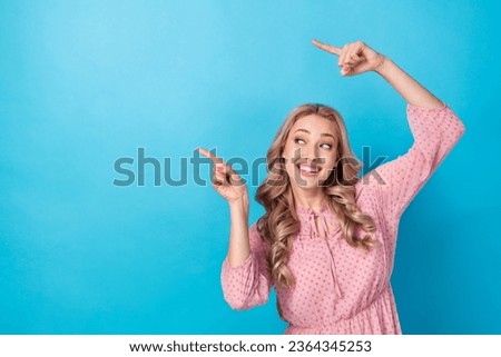 Photo of gorgeous woman with wavy hairdo dressed pink clothes look indicating empty space discount isolated on blue color background