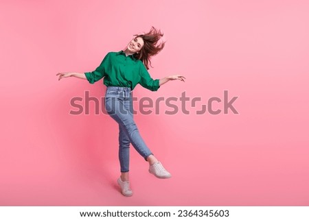 Full length photo of pretty cute lady wear green shirt having fun dancing empty space isolated pink color background