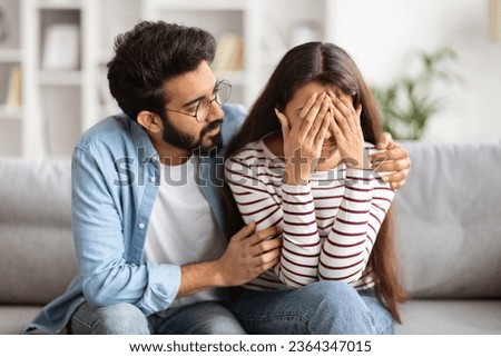 Loving husband indian man comforting consoling upset crying wife woman, giving psychological support care compassion, helping sharing grief or problem, miscarriage, empathy in couple relationships Royalty-Free Stock Photo #2364347015